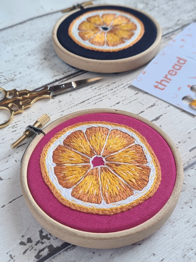 Embroidery hoop with orange segment design
