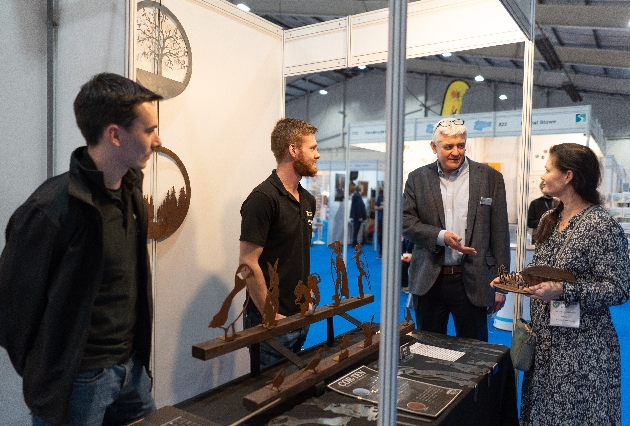 people gathering around a stand at a trade show