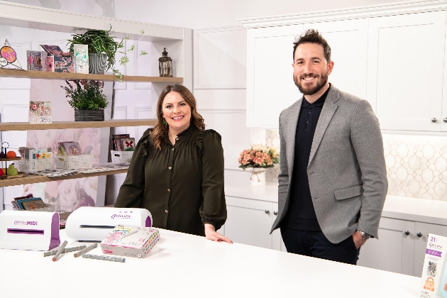 Man and woman  presenters standing at a crafting desk with craft materials