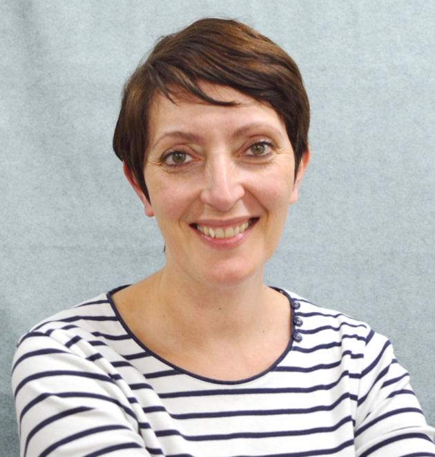 Head shot of Corinne Lapierre wearing a striped top