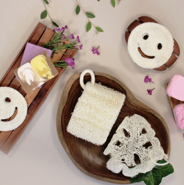 bath tray with sponges on it and tray of soaps