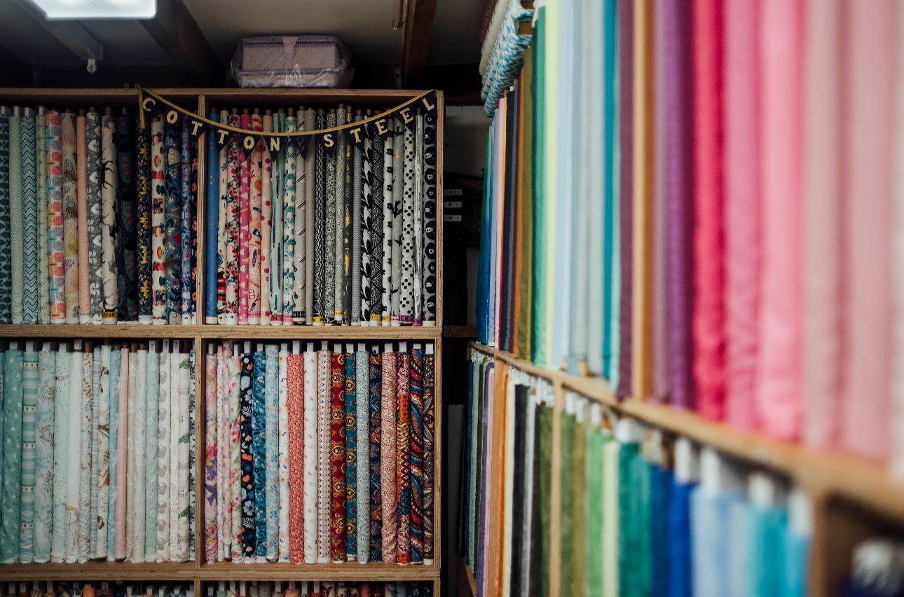 shelves of rows and rows of different coloured and patterned fabrics