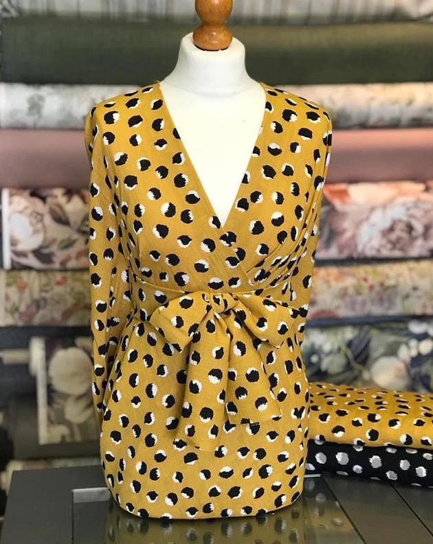 dress on a mannequin in black and yellow material 