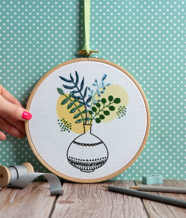 cross stitch kit of leaves in a flower pot in muted colours