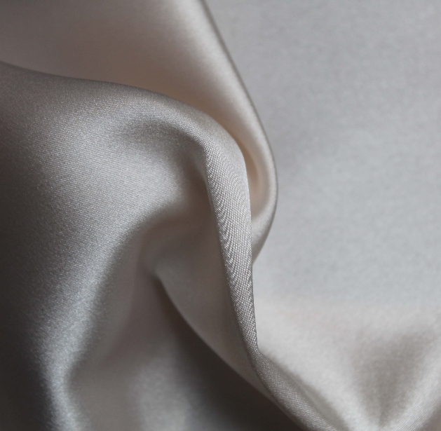 close up of ivory duchess satin fabric