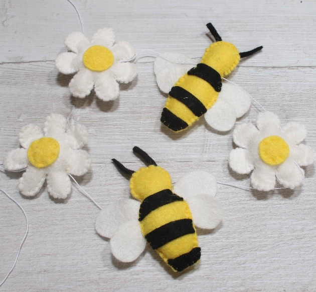 felt bees and flowers on a garland