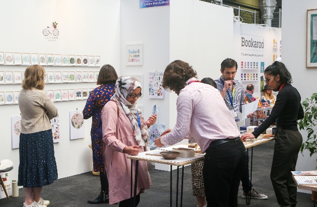 people at a stand in an exhibition hall