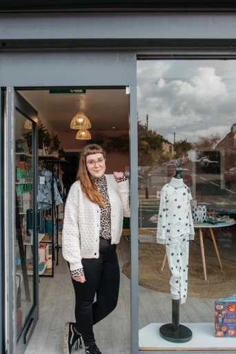 Founder of Small Award shop stood in doorway 