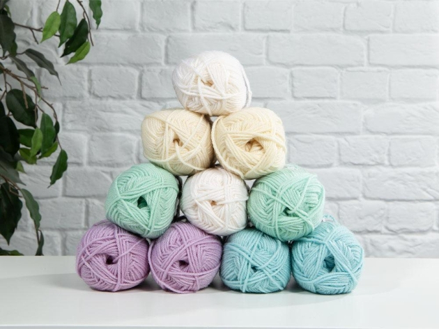 pastel coloured balls of yarn stacked in a pyramid