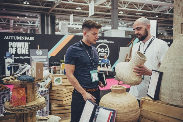 two men discussing clay pots at Autumn Fair exhibition hall