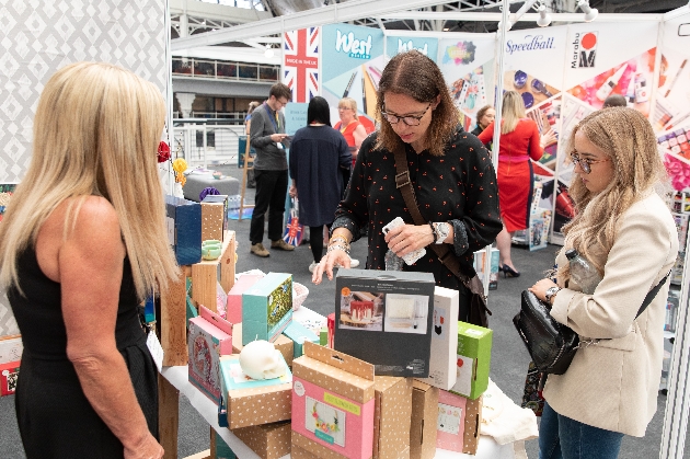 visitors looking at craft kits at exhibition stand