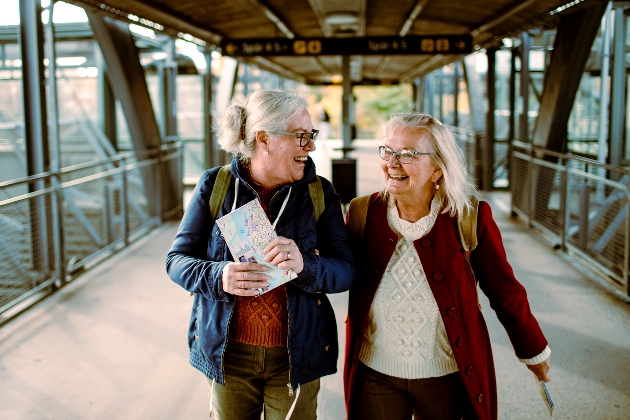 two ladies leaving train station with map