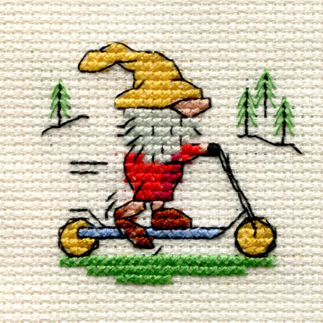 cross stitch of a gnome on a scooter