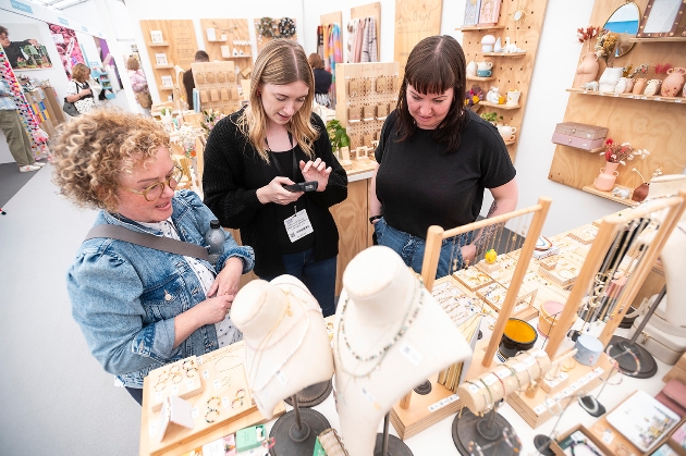 Three women looking at jewellery stand at Home and Gift Show