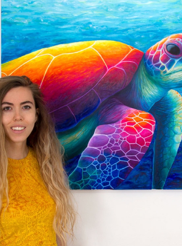 lady standing in front of turtle painting