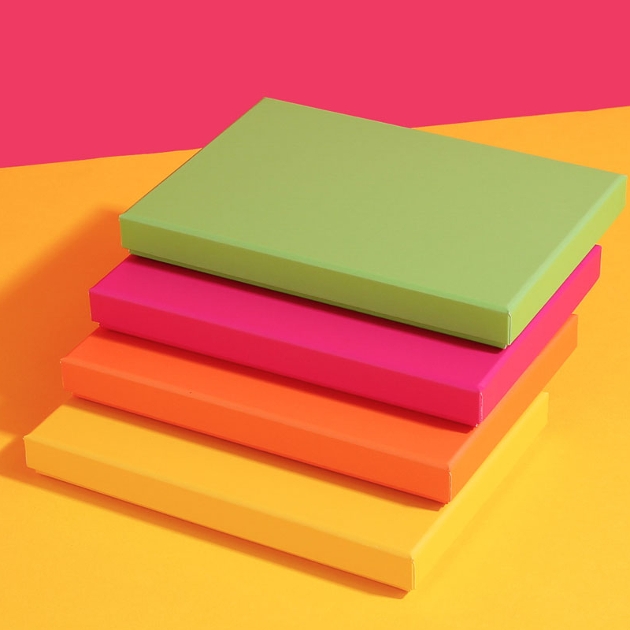 stack of four bright paper gift boxes