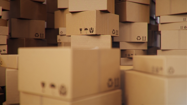hundreds of cardboard boxes stackedup