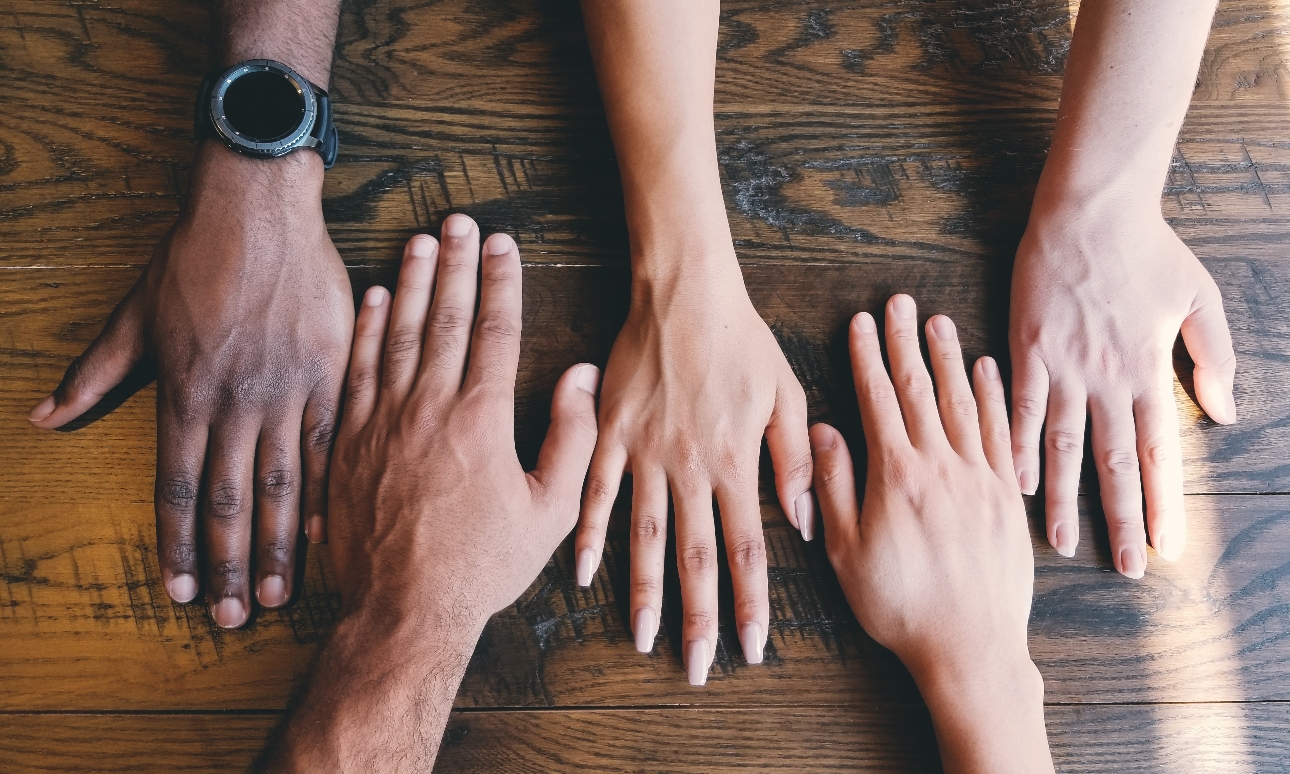 selection of hands on a  table together