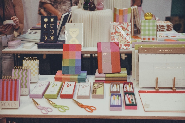 collection of bright notebooks and stationery on display