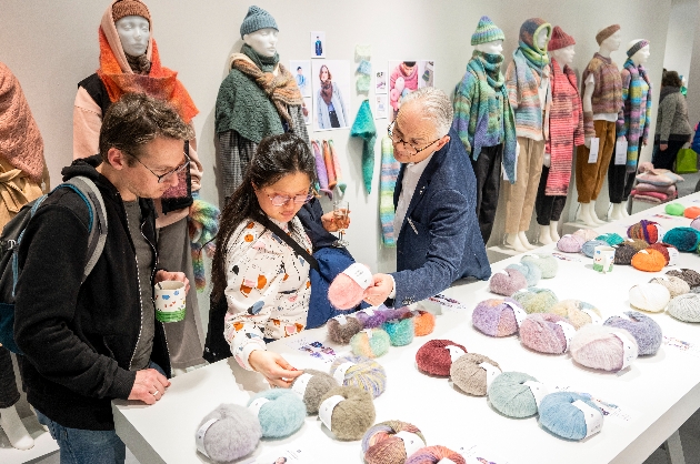 people browsing yarns at trade show