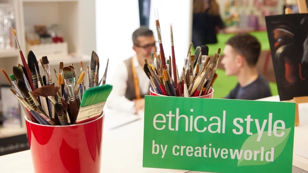pot of paintbrushes next to ethical style sign
