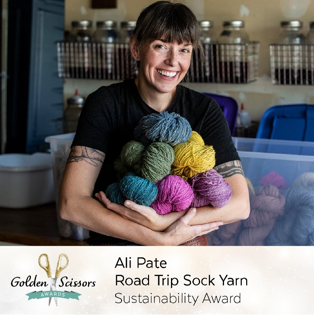 lady with brown fringe holding yarns