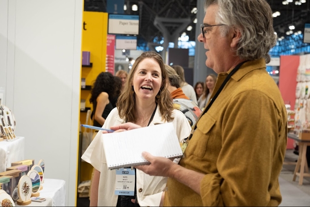 lady laughing placing orders at trade show