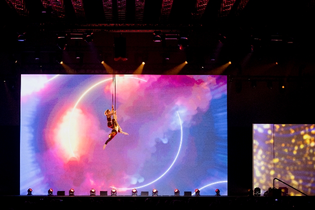 trapeze artist on stage at a conference