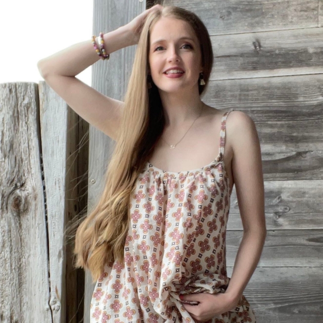 young lady with long light brown hair in floral dress