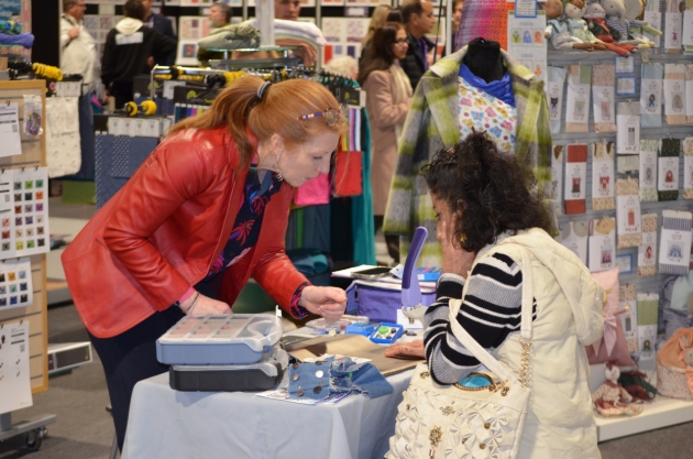 woman looking at crafts at trade show