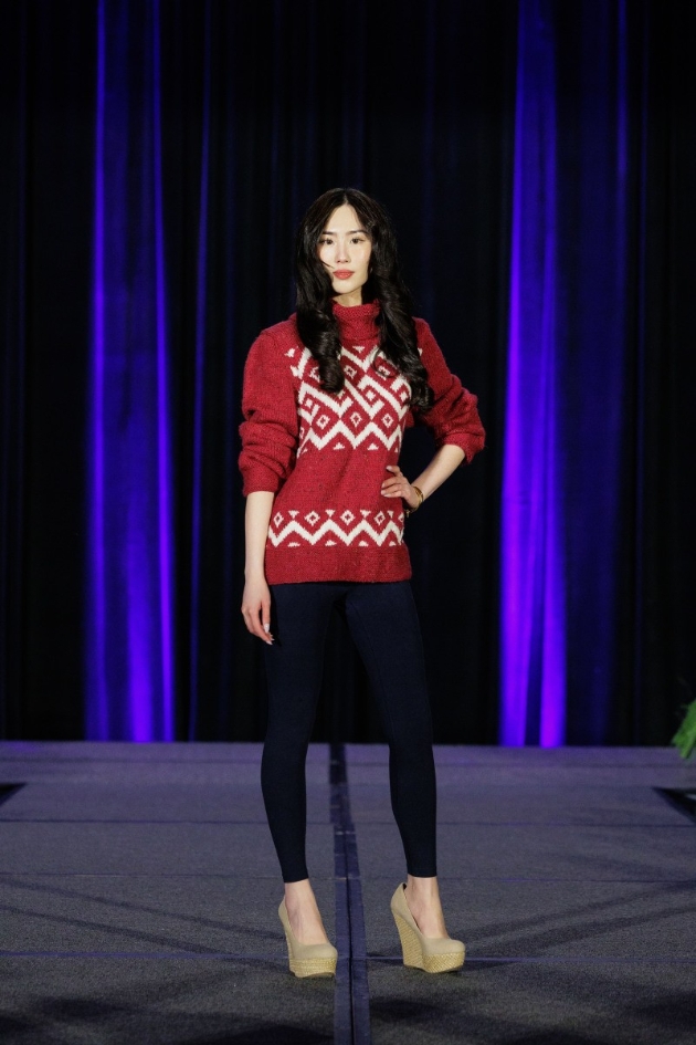 woman wearing red jumper and black leggings on a catwalk