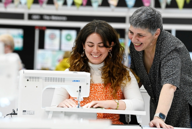 two women using sewing machine
