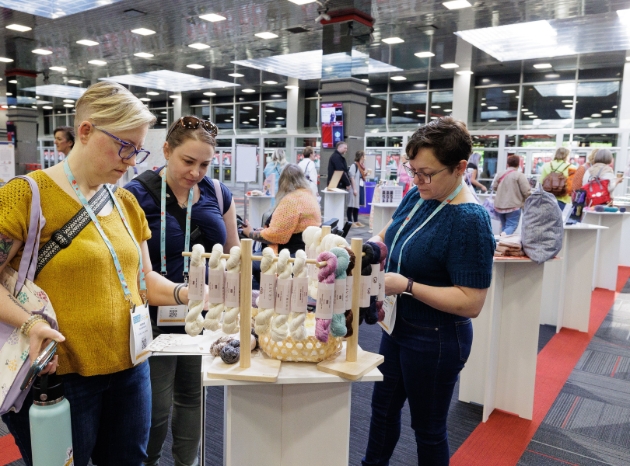 lady looking at yarns at trade fair