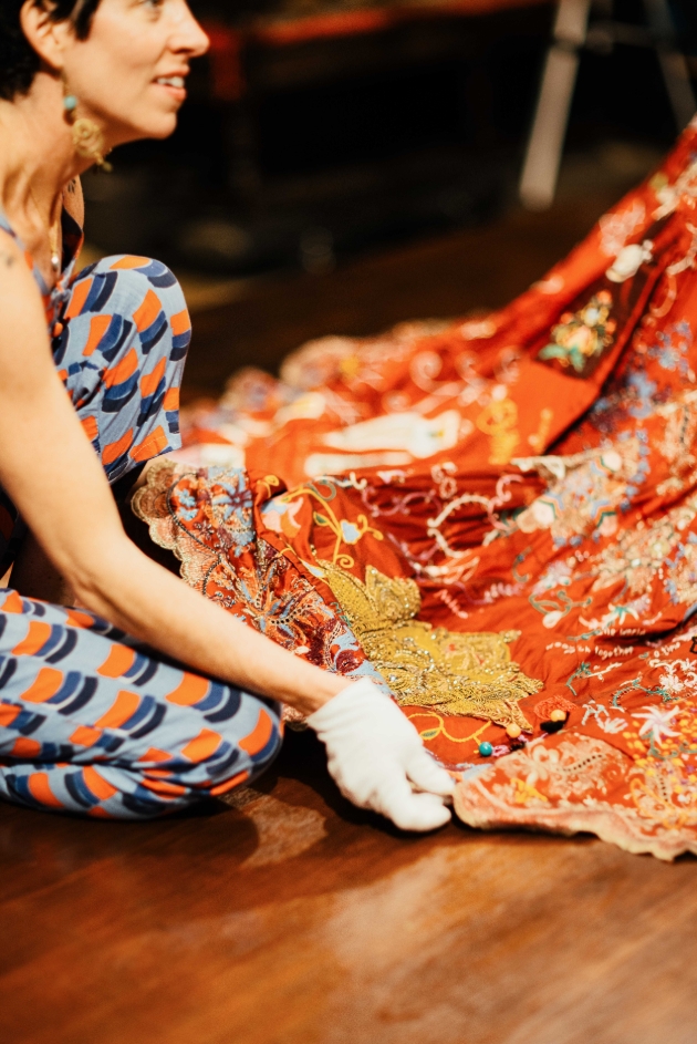 lady working on red woven embroidered dress