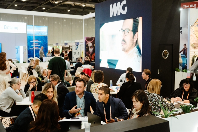 group of people chatting at tables at a conference
