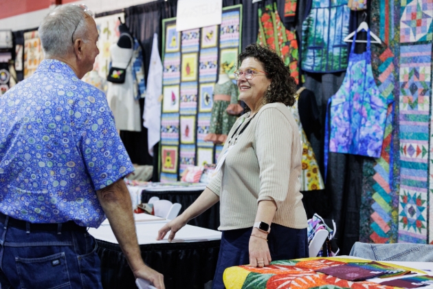 lady and man chatting at trade show stall
