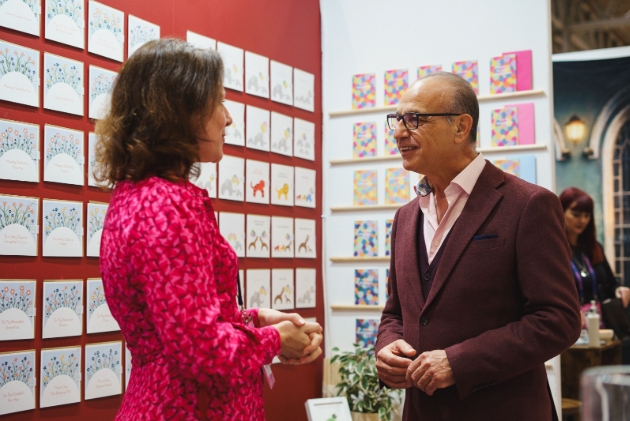 THEO PAPHITIs chatting to lady in pink dress