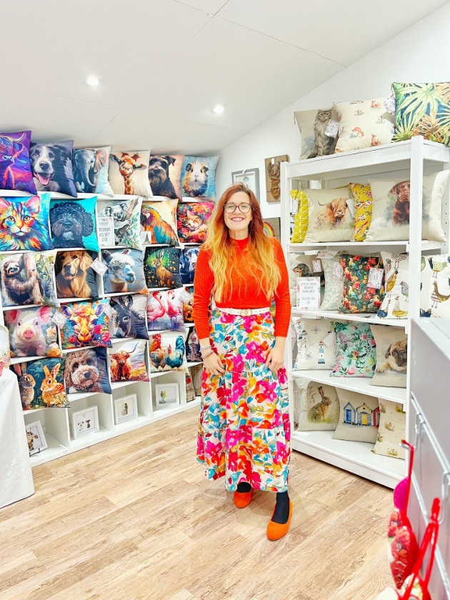 lady standing in front of scatter cushion display