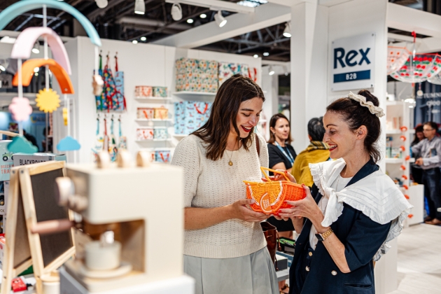 two lady looking at accessories at trade fair