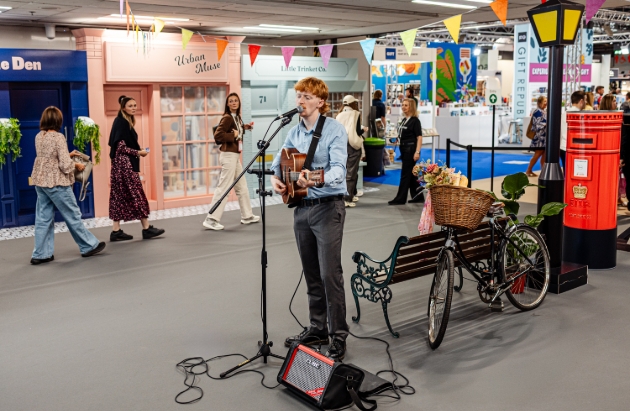 singer and guitarist playing at trade show