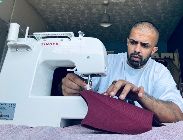 young man using sewing machine