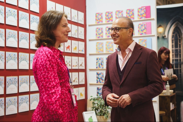 man chatting to lady at greeting card stand