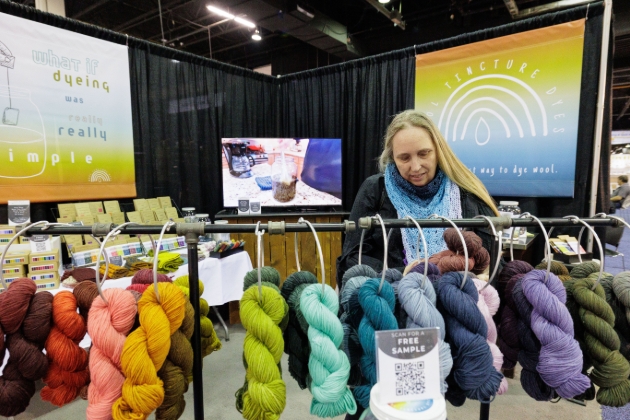 lady looking at yarn bundles