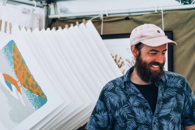 man in baseball cap at art festival