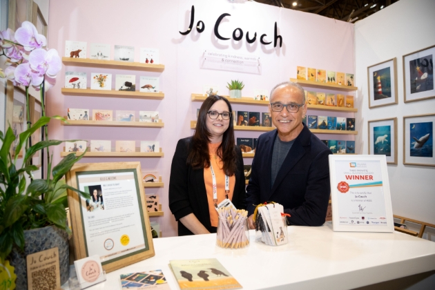 THEO PAPHITIS and lady at trade fair stand