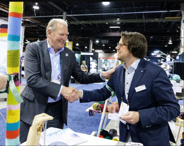 two men shaking hands at trade fair